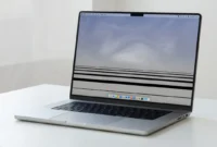 black-lines-bottom-macbook-pro-screen MacBook Pro laptop displaying black horizontal lines at the bottom of the screen on a clean desk