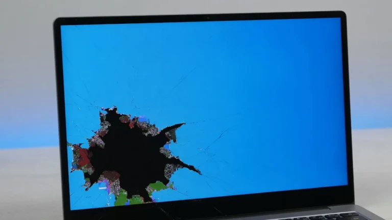 Close-up of a black spot on a Dell laptop screen showing dark irregular LCD damage in lower corner of display
