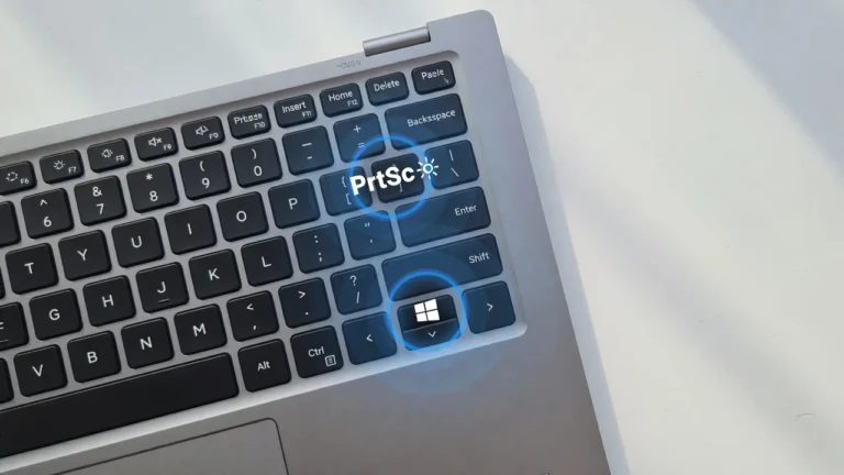 Dell laptop keyboard with Print Screen key and Windows key highlighted for taking screenshots